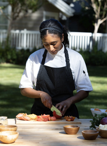 Chef slicing tomatoes