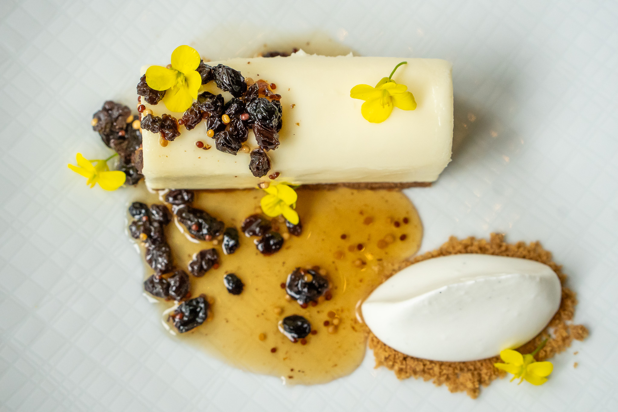 Cheesecake dessert with mustard flowers.