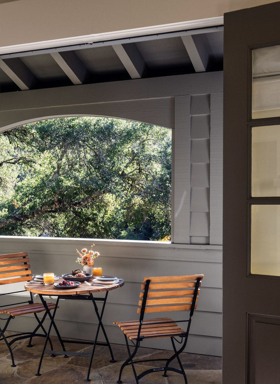 Breakfast set on table outdoors on Cottage Room porch