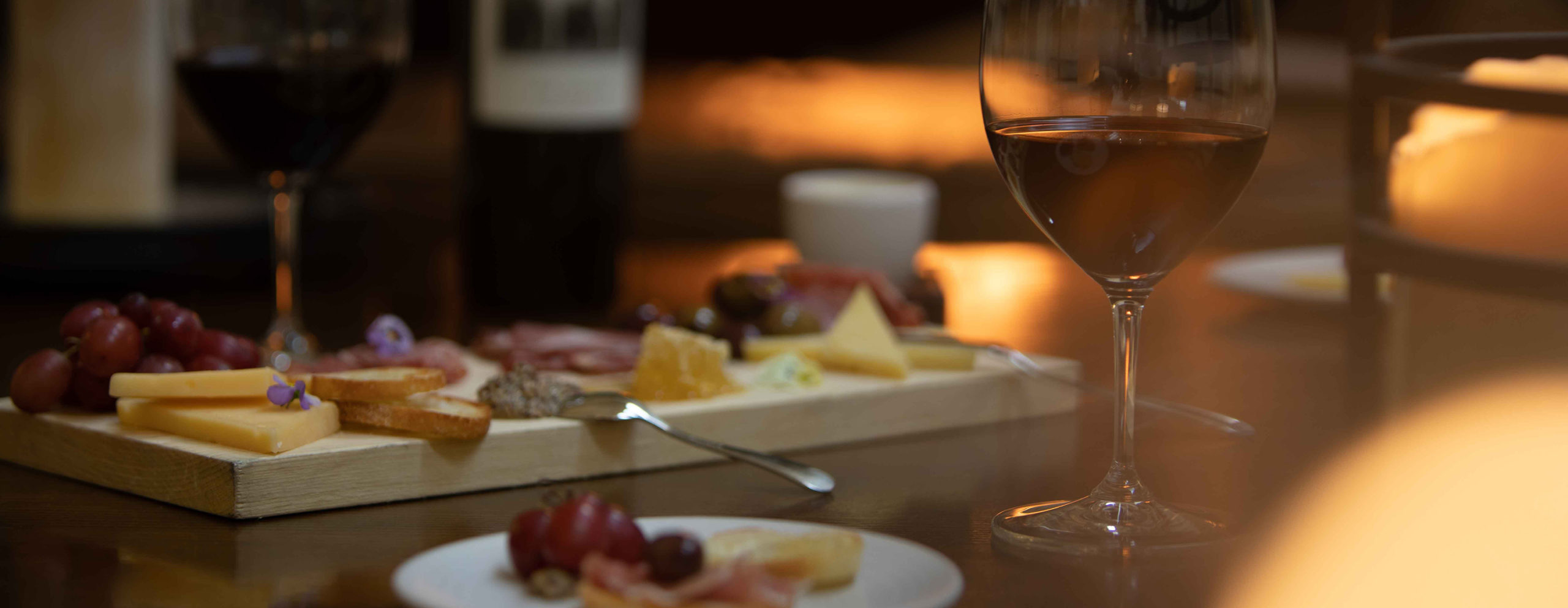 Charcuterie board and glass of red wine