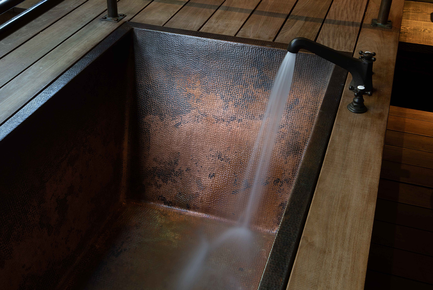 Water flowing into copper tub in the spa Tree house room