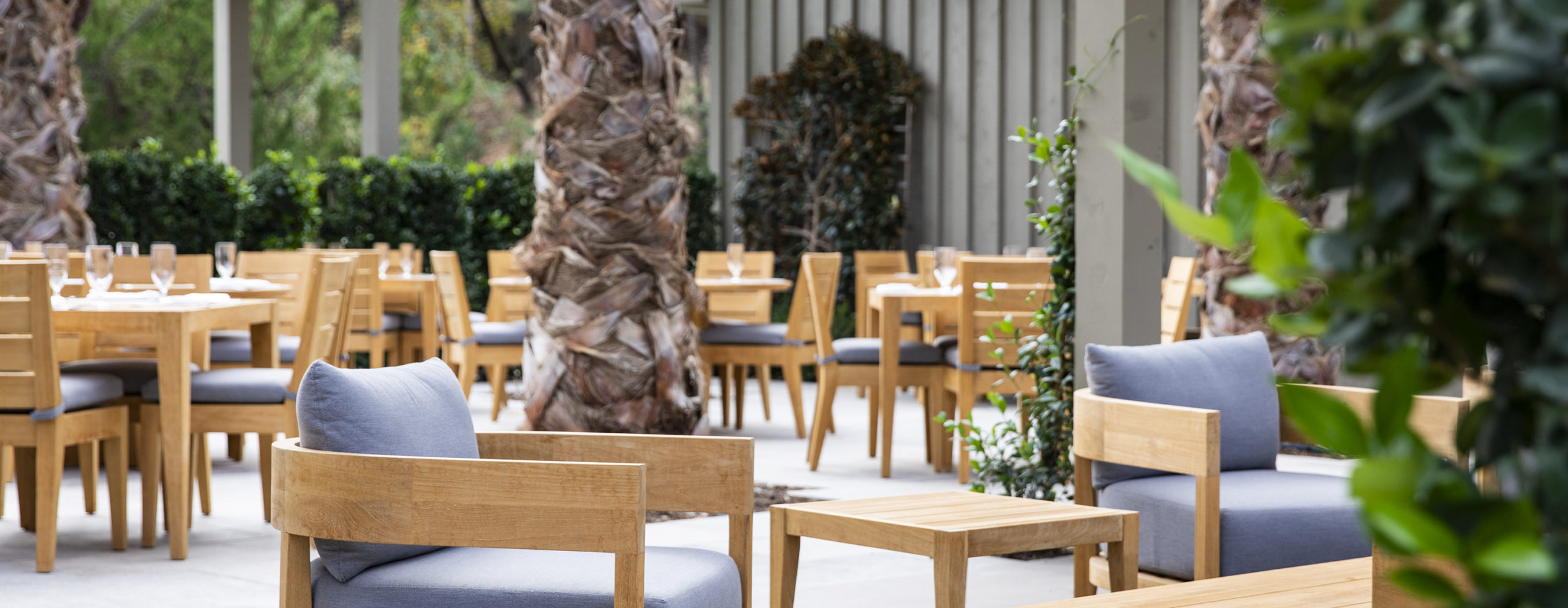 Exterior view of the outdoor Terrace Cafe with tables and chairs at our Napa Valley restaurant.