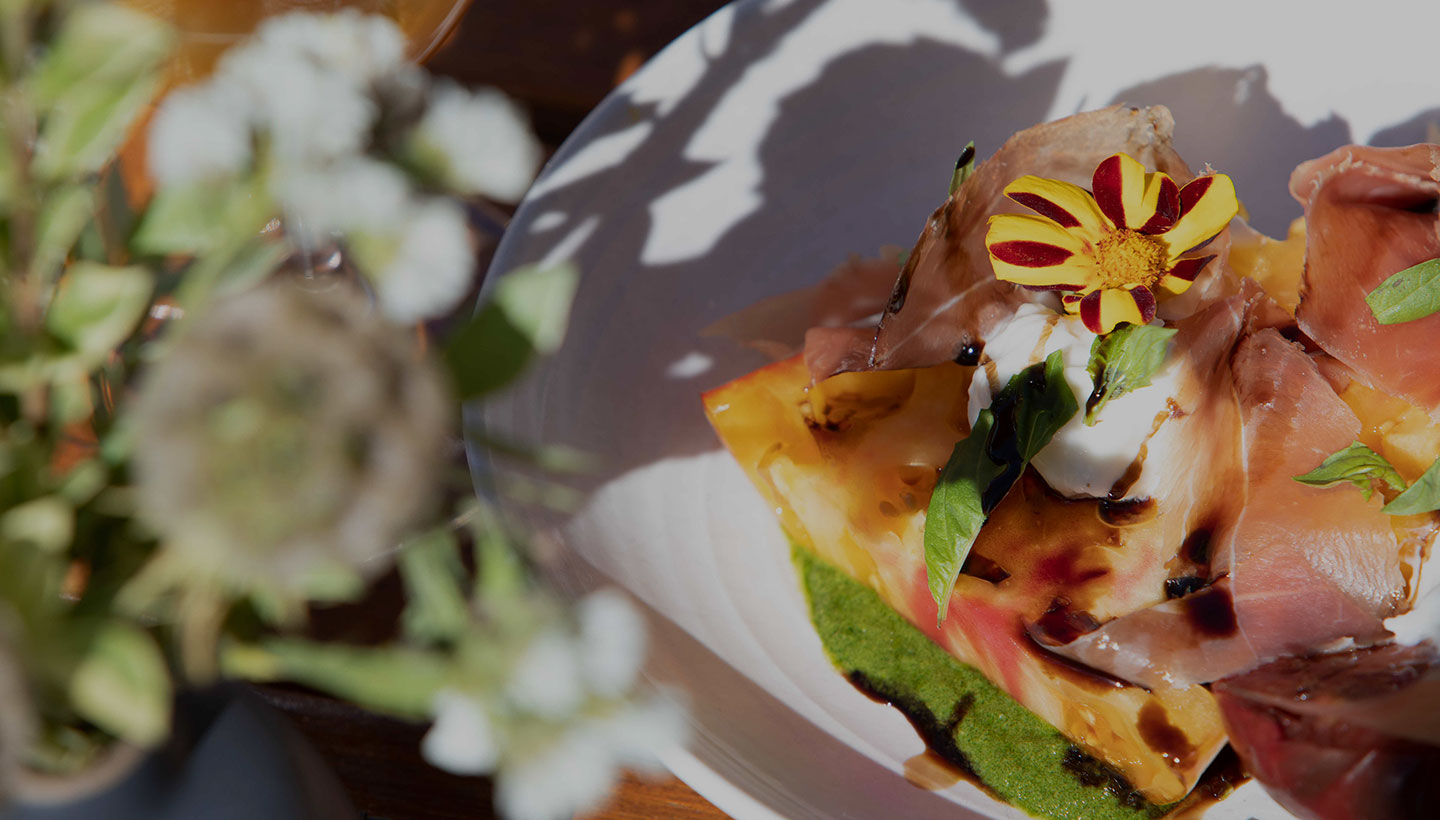 Close up image of a heirloom tomato and prosciutto dish at our Napa Valley, California restaurant.