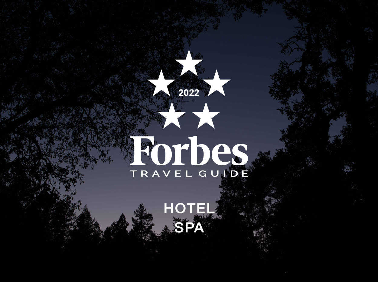 Evening sky with Forbes Five-Star logo in the middle