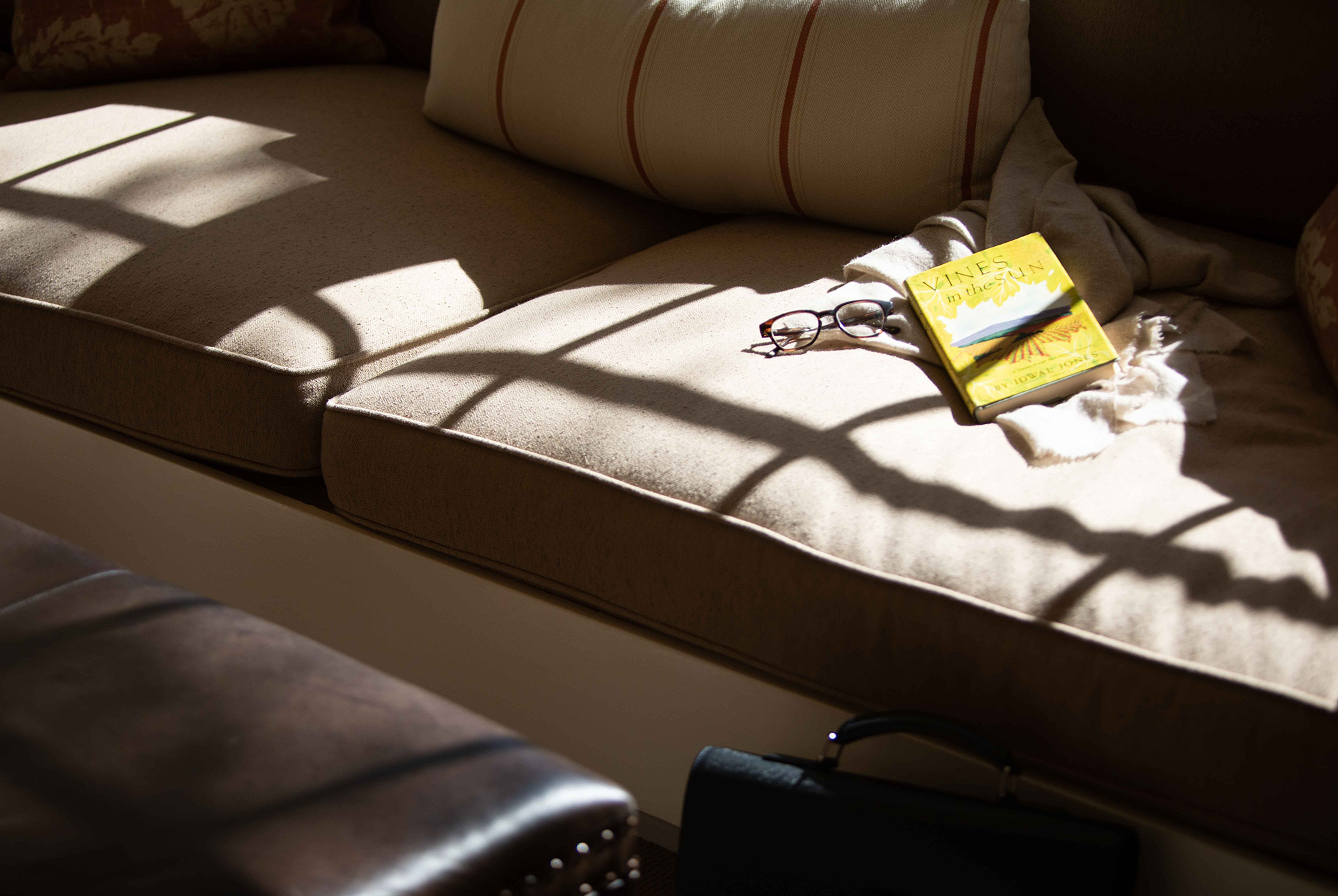 Window seat with book and reading glasses