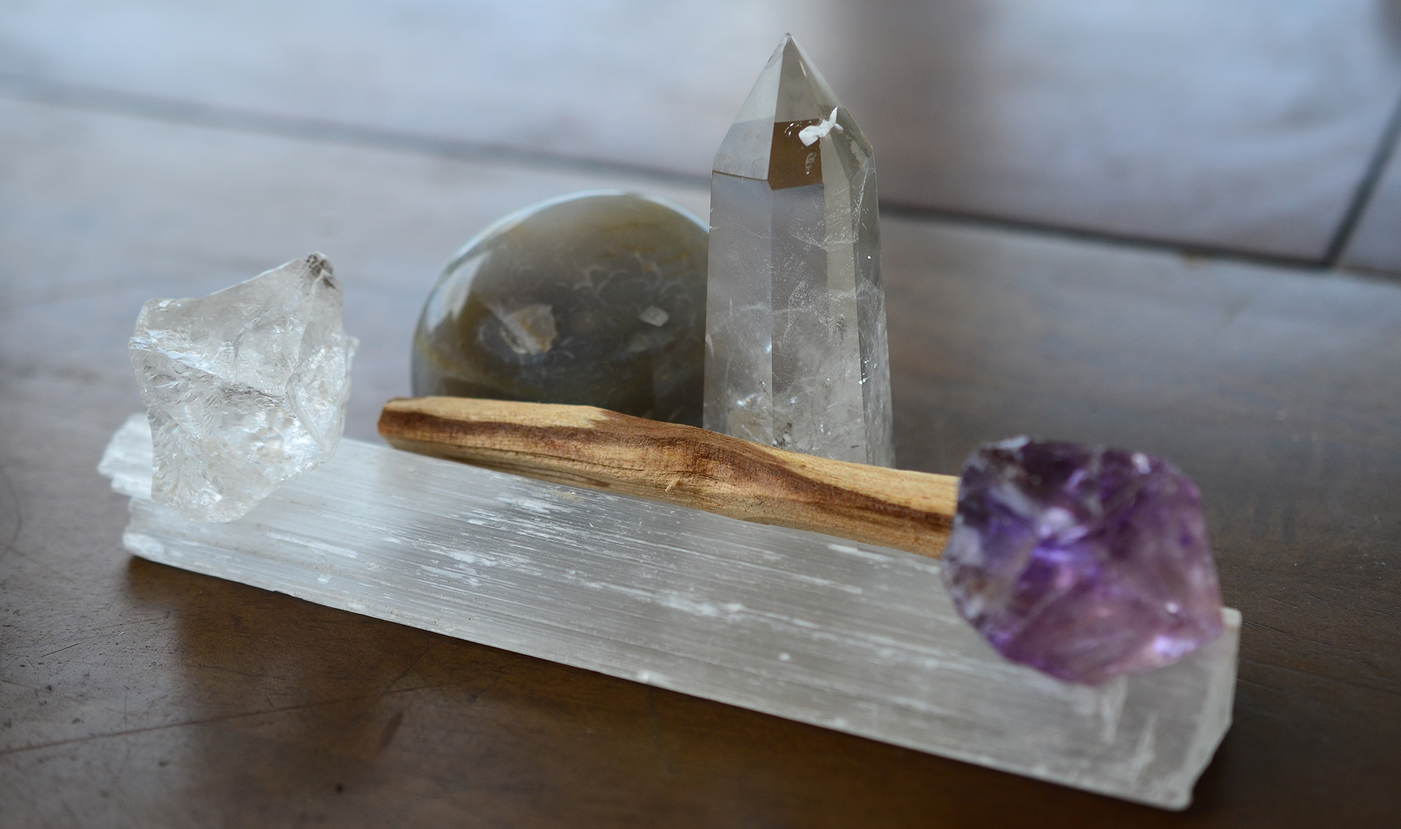 Close up image of an assortment of healing crystals, clear quartz tower, and a selenite rod at our luxury spa resort near St. Helena.