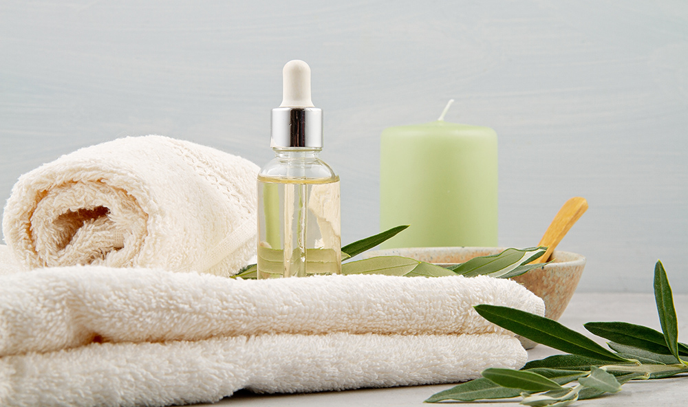 Spa and wellness composition with serum, towels and beauty products