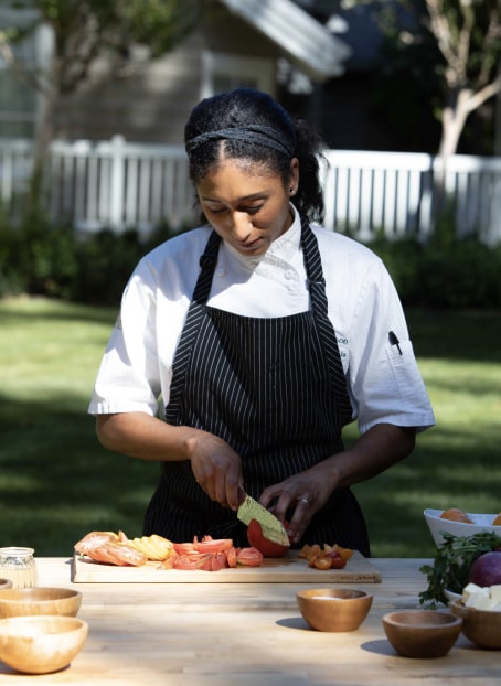 image of a chef preparing a meal outside at Meadowood Napa Valley resort