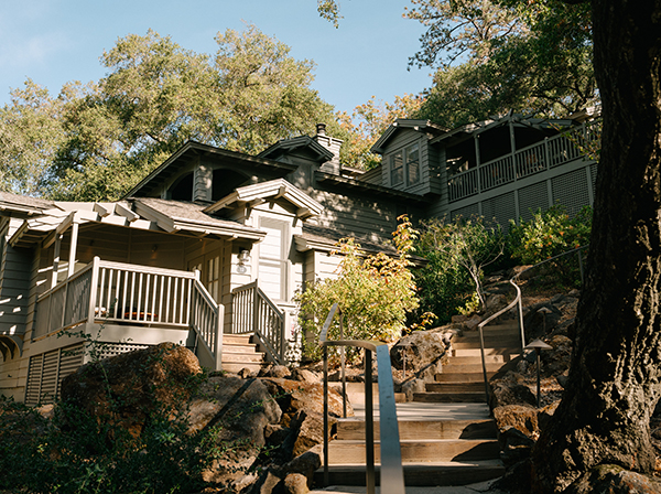 Curved wooden stairs leading up to a building with balconies on multiple levels at our luxury resort in Napa Valley, CA.